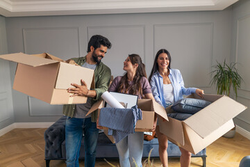 Friends becoming roommates moving in in their new apartment.