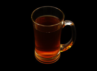Glass cup of tea isolated on black background