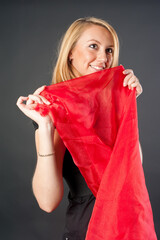 Young pretty woman in black with red scarf