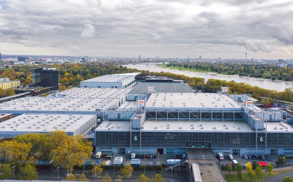 Aerial view over Messe D&uuml;sseldorf Convention Center, urban cityscape on the background. Dusseldorf, Germany - October 2021