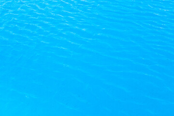Water in the pool with blue texture background. Close up