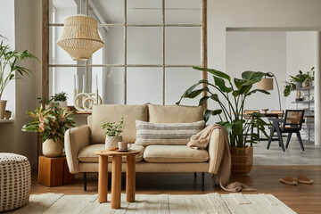 Elegant living room interior design with beige modern sofa, coffee table and creative accessories....