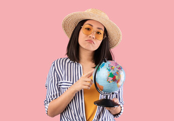 Sad Asian Woman Holding Globe, Pointing At Map