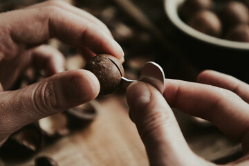 macadamia key in the hands of a man