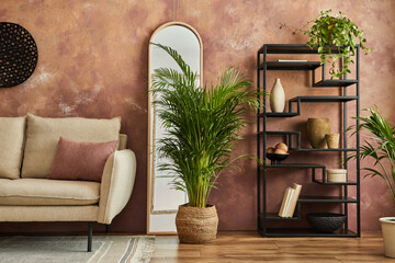 Elegant living room interior design with beige modern sofa, black metal shelf, mirror, plants and stylish accessories. Creative wallpaper. Template. Copy space.