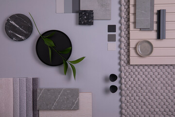 Elegant  flat lay composition in grey and black color palette with textile and paint samples, lamella panels and tiles. Architect and interior designer moodboard. Top view. Copy space.