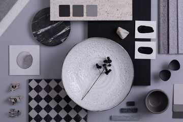 Creative flat lay composition in grey and black color palette with textile and paint samples,...