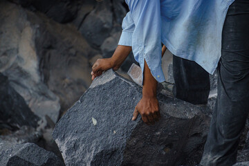 close up of a hands and a volcanic rock