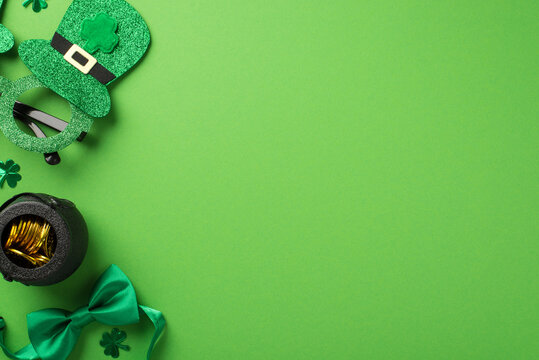 Top view photo of st patricks day decorations hat shaped party glasses green bow-tie shamrocks confetti and pot with gold coins on isolated pastel green background with blank space