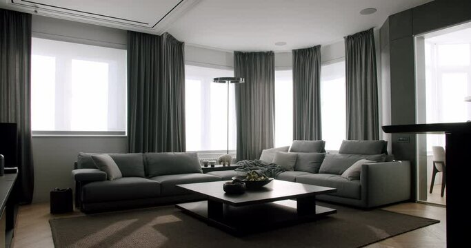 Contemporary interior design of the living room. Modern Gray Sofa and Curtains. Minimalist Lamp.Fashionable furniture store. Minimalist Home Interior. Cozy Modern Furniture Design. Luxury Elegant Room