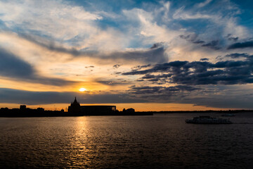 Dramatic colorful golden susnet sky with clouds over the Volga river - sun goes down, evening time, warm light. Calm, peaceful, atmospheric view, relaxation concept