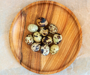 Quail eggs on a wooden plate