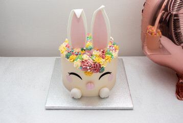 Trendy cake for children's Birthday party or Ester. Cheerful bunny with a muzzle and ears....