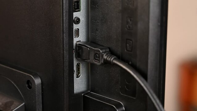 A standard DisplayPort DP cable is plugged in to a DisplayPort socket