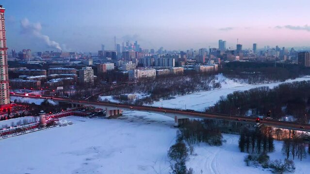 Aerial View Of Bridge Above Frozen River Among Moscow City At Evening Dawn In Winter