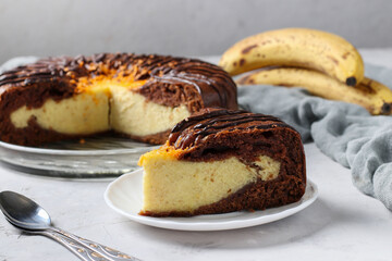 Homemade Chocolate Cake with cottage cheese and banana filling, with piece of cake cut off in the foreground