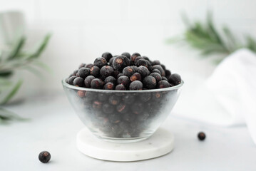 frozen blackcurrant berries in a glass bowl