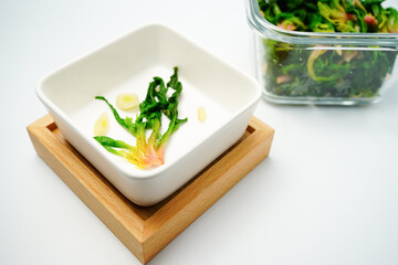 Sigeumchi namul is a Korean side dish. It is Parboiled spinach seasoned with salt, chopped green onion and garlic, sesame oil, and sesame seeds