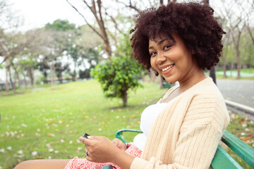 Businesswoman using smartphone search information for work in the public park. Way to success, To communicate, plan and relax. Use as the article and texture.