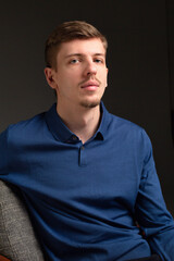 Obraz premium Attractive young blond european man with short beard and mustache isolated on black portrait
