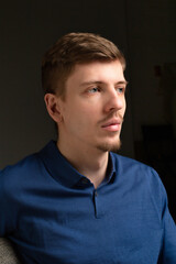 Obraz premium Attractive young blond european man with short beard and mustache isolated on black portrait