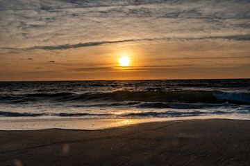 Waves breaking onto the shore at sunrise