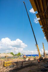 truck crane at a construction site, lifts a metal structure