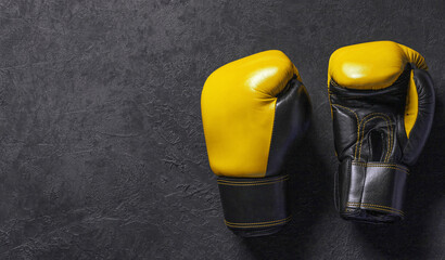 Yellow boxing gloves on a black background