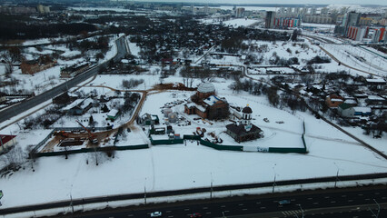Suburb of a big city. City block from the height of the flight. Winter cityscape. Aerial photography.