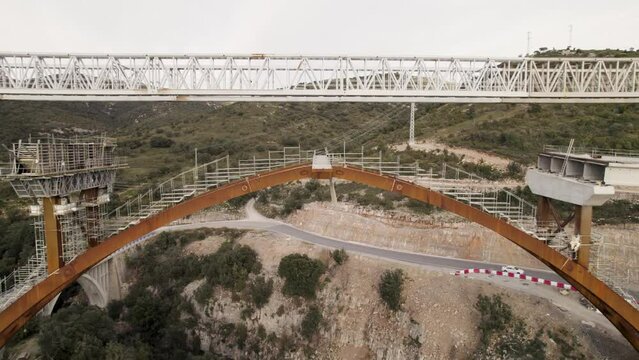 Backward motion video revealing a new bridge&acute;s structure under construction in Barranco de la Bota in Morella