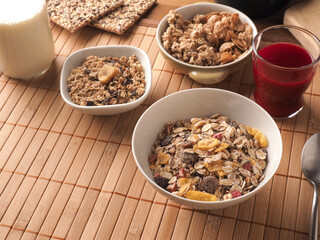 Rich breakfast with organic cereals and ingredients on a wooden table, healthy food concept