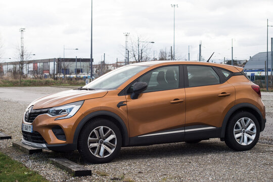 Mulhouse - France - 17 February 2022 - Profile View Of Orange Renault Captur SUV Car Parked In The Street