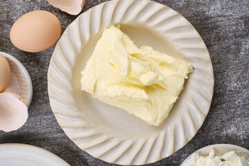 Muffin, baking ingredients: Butter, broken eggs in plates on the table