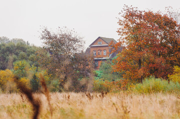 Autumn landscape panorama photography, the European part of the Earth. Druya, Belarus. Rural landscape with a rainy sky. Green field and village on the horizon