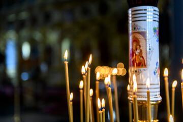Church candles on the background of icons in Russian orthodox cathedral