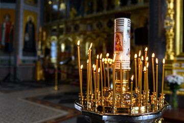 Church candles on the background of icons in Russian orthodox cathedral