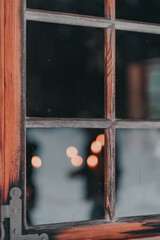 Wooden window frame with glass and blurry lights in the window. Bokeh (1188)