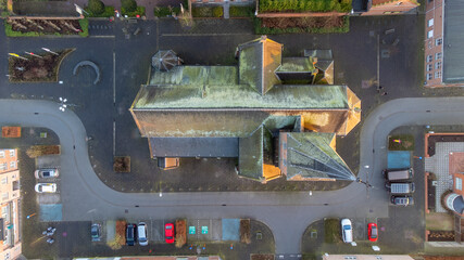 Fototapeta na wymiar Rijkevorsel, Belgium, 28 January 2022. Sint Jozef Rijkevorsel old street and a view of Saint Joseph's Church from above. Aerial drone view. High quality photo