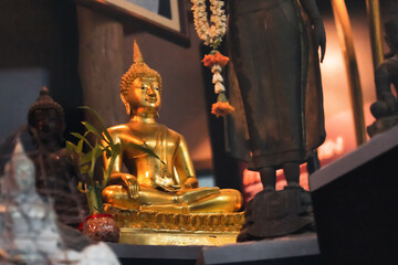 Small golden Buddha images made of brass are placed in Buddhist houses.
