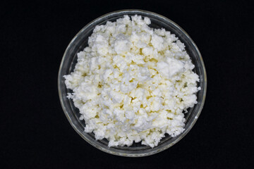 cottage cheese in a glass bowl close-up top view