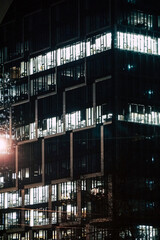 Plakat Office building with glass facade - night photograph