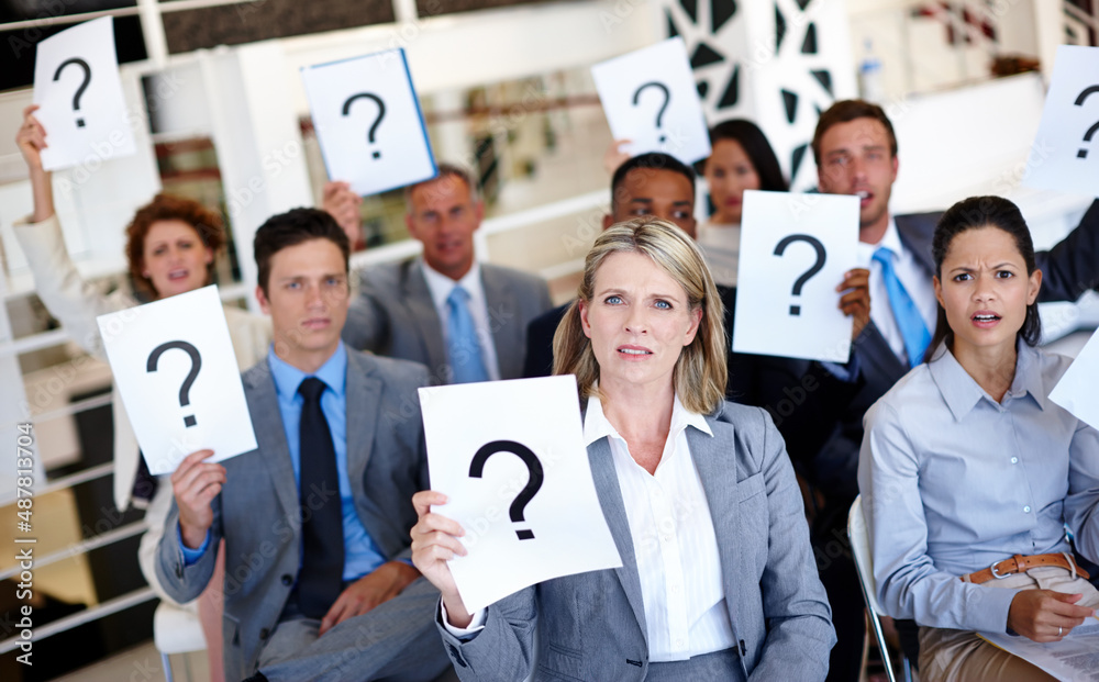 Leinwandbilder stop leaving us in the dark. shot of a group of businesspeople holding up signs with question marks 