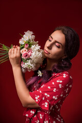 beautiful girl in a red dress on a red background with flowers