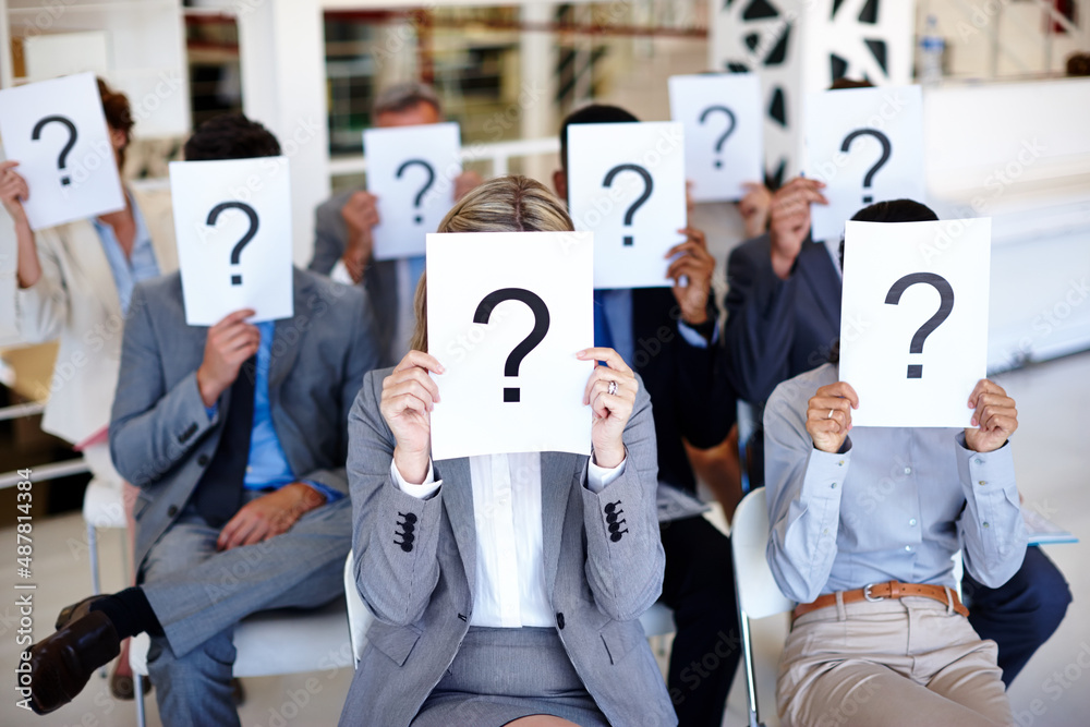 Poster shed a little light on this. shot of a group of businesspeople holding up signs with question marks 