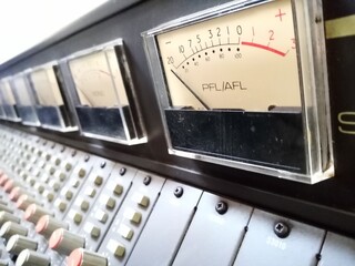 PFL/AFL VU meter in sharp focus,on a vintage analogue ,multi channel ,studio mixing console