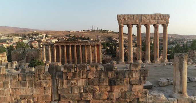 Aerial  forward view of Bacchus and Jupiter temples. Site of Baalbek with modern city in the background. Lebanon. 