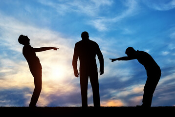 Silhouettes of two men laughing at a sad man pointing a finger at him.