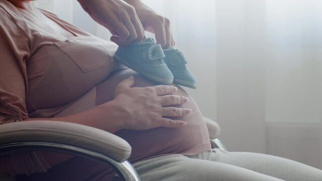 Happy pregnant wife and husband feels love and relax at home. Father take care of pregnant mother. Happy family waiting a new born baby. Concept of maternity and pregnancy care. Slow motion.