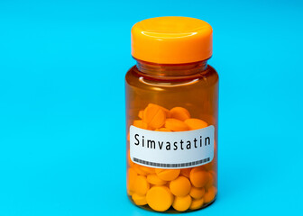 Medical vial with Simvastatin pills. Medical pills in orange Plastic Prescription