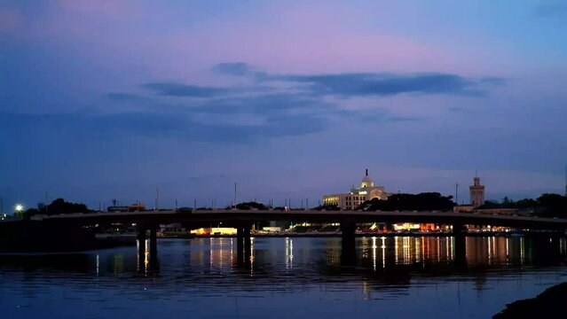 Evening photo of the Iloilo River showing in the background the iconic and historic Iloilo City Customs House and Post Office Building, Philippines, built during the American colonial period.